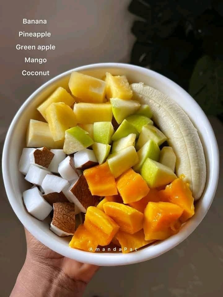 Fruit bowl of banana, pineapple, green apple, mango and coconut